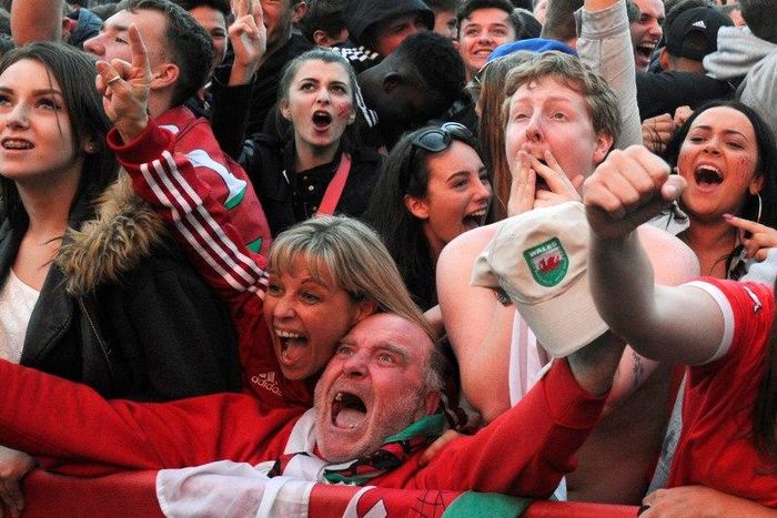 Welsh fans cheer the second goal scored by Wales, during the Wales v Belgium match being shown on a big screen in the Fanzone, Coopers Field, Cardiff, Wales, July 1, 2016.