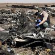 A military investigator from Russia stands near the debris of a Russian airliner at its crash site at the Hassana area in Arish city, north Egypt, in this November 1, 2015 file photo.
