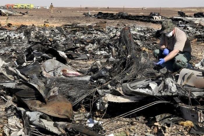 A military investigator from Russia stands near the debris of a Russian airliner at its crash site at the Hassana area in Arish city, north Egypt, in this November 1, 2015 file photo.