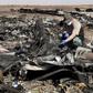 A military investigator from Russia stands near the debris of a Russian airliner at its crash site at the Hassana area in Arish city, north Egypt, in this November 1, 2015 file photo.