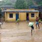 Youths play soccer in the rain at the Ndako ya Biso (Our House) refugee centre for street children in the Democratic Republic of Congo's capital Kinshasa, February 5, 2016. Picture taken February 5, 2016. REUTERS/Aaron Ross