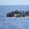 Migrants are seen on a capsizing boat before a rescue operation by Italian navy ships "Bettica" and "Bergamini" off the coast of Libya in this handout picture released by the Italian Marina Militare on May 25, 2016.