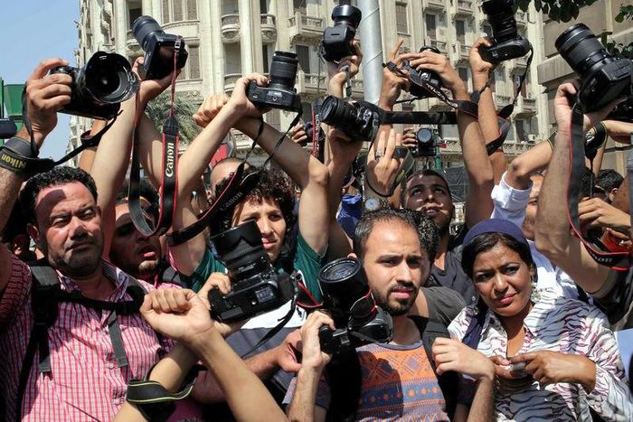 Egyptian journalists hold up their cameras outside the Egyptian Press Syndicate in downtown Cairo, Egypt April 28, 2016, during a protest against the interior minister following the arrest of colleagues for covering anti-government demonstrations.