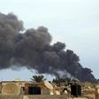 Smoke billows from a factory after an airstrike by forces loyal to former general Khalifa Haftar, in Benghazi October 22, 2014. REUTERS/Stringer