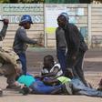 Riot police detain residents of Epworth suburb after a protest by taxi drivers turned violent in Harare, Zimbabwe, July 4, 2016.