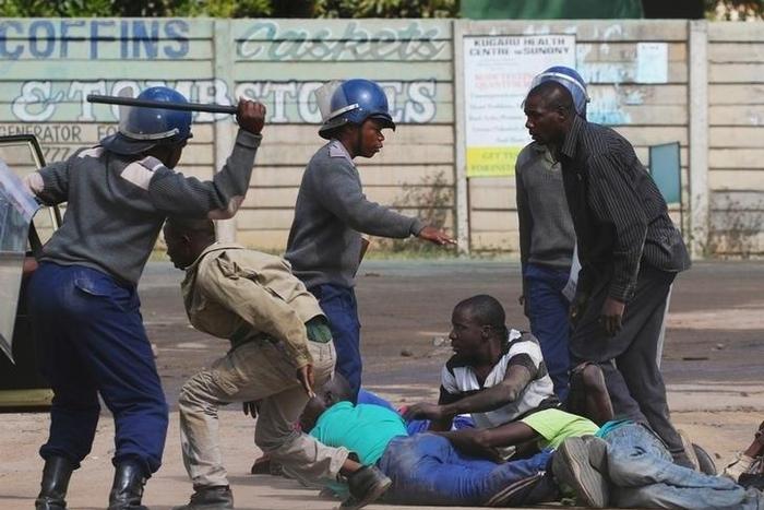 Riot police detain residents of Epworth suburb after a protest by taxi drivers turned violent in Harare, Zimbabwe, July 4, 2016.