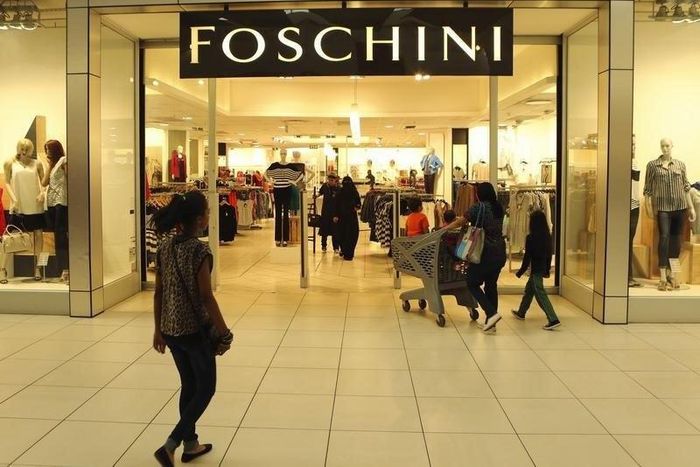 A shopper walks past a Foschini store at a shopping centre in Lenasia, south of Johannesburg, August 28, 2013. REUTERS/Siphiwe Sibeko