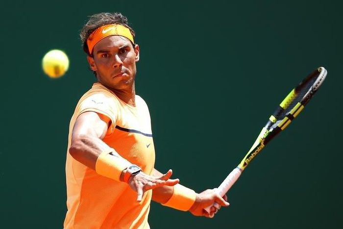 Rafael Nadal of Spain plays a shot to Stan Wawrinka of Switzerland