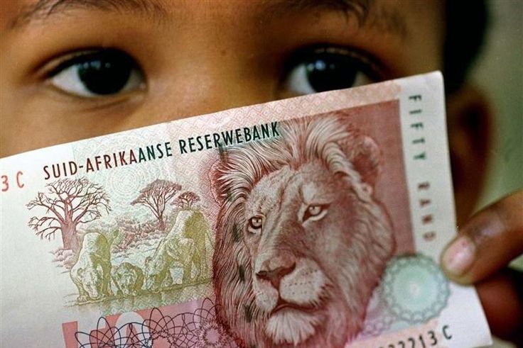 A South African child holds a 50 rand note  in a file photo.