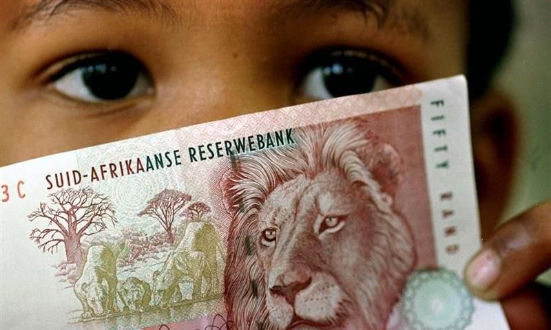 A South African child holds a 50 rand note  in a file photo.