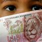 A South African child holds a 50 rand note , file.