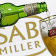 Photo illustration of beer flowing from a bottle of Stella Artois into a glass, seen against a SAB Miller logo, November 5, 2015.   REUTERS/Dado Ruvic/Illustration/File Photo