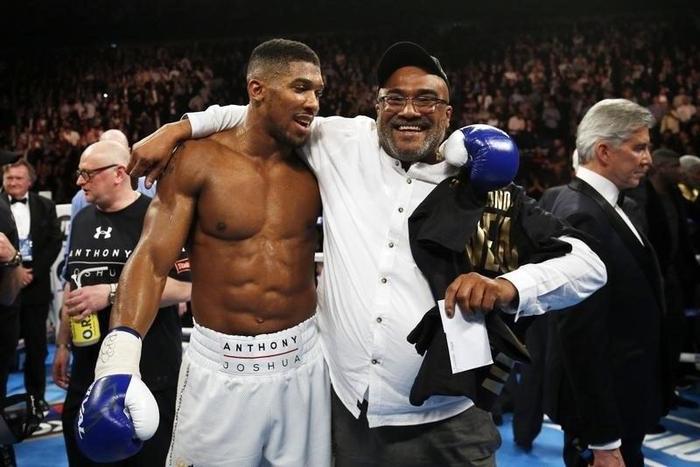 Anthony Joshua celebrates his win with his father Jonathan