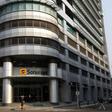 A woman walks past the head office of Angolan state oil company Sonangol in the capital Luanda, August 26, 2012.