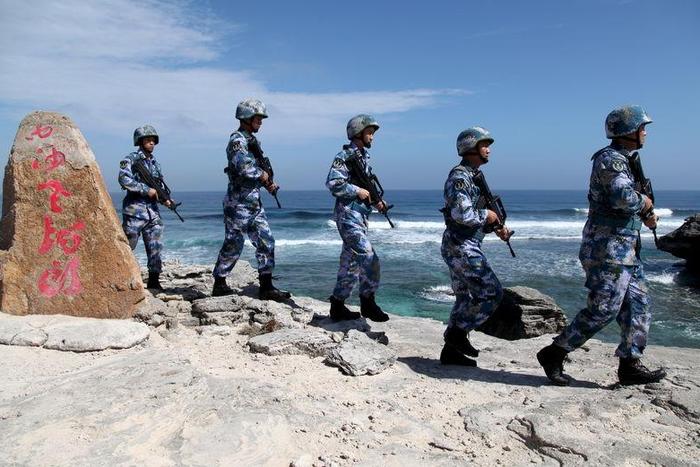 Soldiers of China's People's Liberation Army (PLA) Navy patrol at Woody Island, in the Paracel Archipelago, which is known in China as the Xisha Islands, January 29, 2016. REUTERS/Stringer