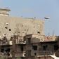 Buildings damaged during clashes between military forces loyal to Libya's eastern government and the Shura Council of Libyan Revolutionaries, an alliance of former anti-Gaddafi rebels who have joined forces with the Islamist group Ansar al-Sharia, are ...