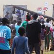 People use a pole to batter a shop doorway during clashes with police in Lusaka April 19, 2016.