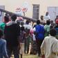 People use a pole to batter a shop doorway during clashes with police in Lusaka April 19, 2016.