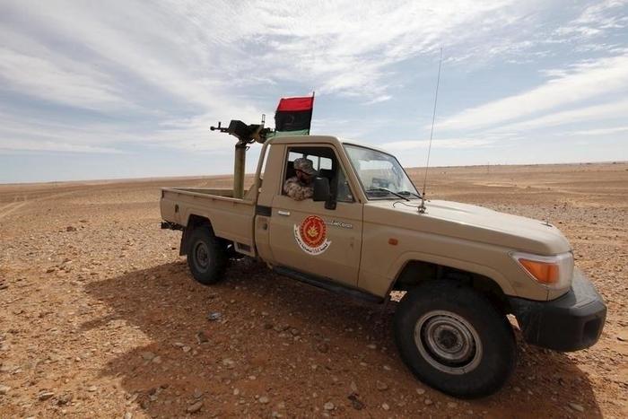 A Libyan soldier sits in a military vehicle at military outpost in Wadi Bey, west of the Islamic State-held city of Sirte, February 23, 2016. REUTERS/Ismail Zitouny