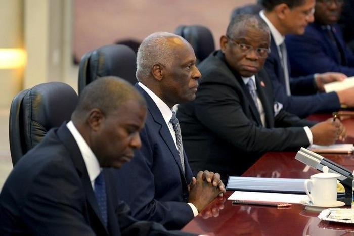 Angola's President Jose Eduardo dos Santos (C) listens to China's Premier Li Keqiang (not pictured) at the Great Hall of the People in Beijing, June 9, 2015.