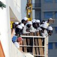 Migrants and refugees arrive at the Trapani port on the Aquarius vessel on July 22, 2016 after being rescued at sea 