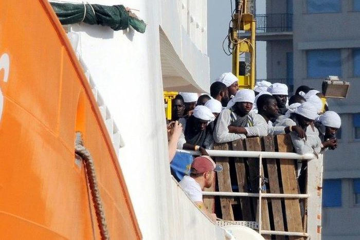 Migrants and refugees arrive at the Trapani port on the Aquarius vessel on July 22, 2016 after being rescued at sea 