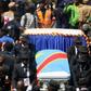 A general view taken through a window shows mourners escorting the casket of legendary Congolese singer Papa Wemba, born Jules Shungu Wembadio Pene Kikumba, from the the Notre Dame du Congo Cathedral for burial, along the streets of the Democratic Repu...