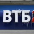 A sign displaying the logotype of VTB Bank, covered with icicles, is seen above the bank office in central Moscow, file.