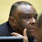 Former Congo vice-president Jean-Pierre Bemba looks up when sitting in the courtroom of the International Criminal Court to stand trial with Aime Kilolo Musamba, Jean-Jacques Mangenda Kabongo, Fidele Babala Wandu and Narcisse Arido, on charges includin...