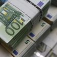 Wads of euro banknotes are stacked in a pile at the Money Service Austria company's headquarters in Vienna, Austria, March 3, 2016.