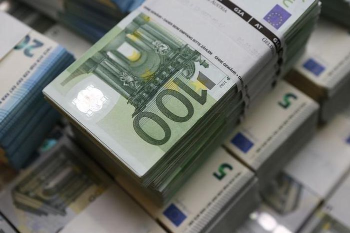 Wads of euro banknotes are stacked in a pile at the Money Service Austria company's headquarters in Vienna, Austria, March 3, 2016.