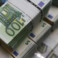Wads of euro banknotes are stacked in a pile at the Money Service Austria company's headquarters in Vienna, Austria, March 3, 2016.