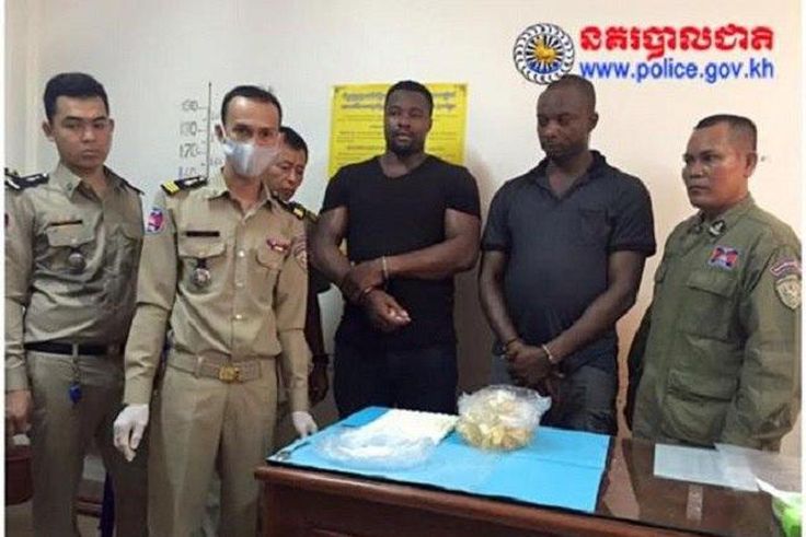 The suspects, Anthony Ifeanyi Okafor and Paschal Adibe with Cambodian police officials