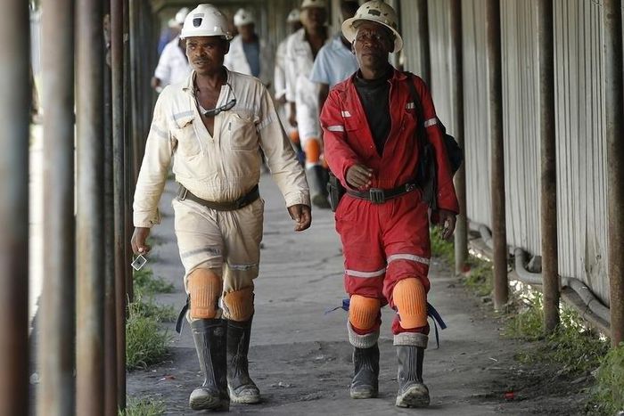 Miners walk at the end of their shift at the Anglo Platinum's Khuseleka shaft 1 mine in Rustenburg, northwest of Johannesburg, January 15, 2013. REUTERS/Siphiwe Sibeko