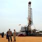 Workers are seen at an oil exploration site in Bulisa district approximately 244km (152 miles) North-West of Kampala January 20, 2012. REUTERS/Stringer