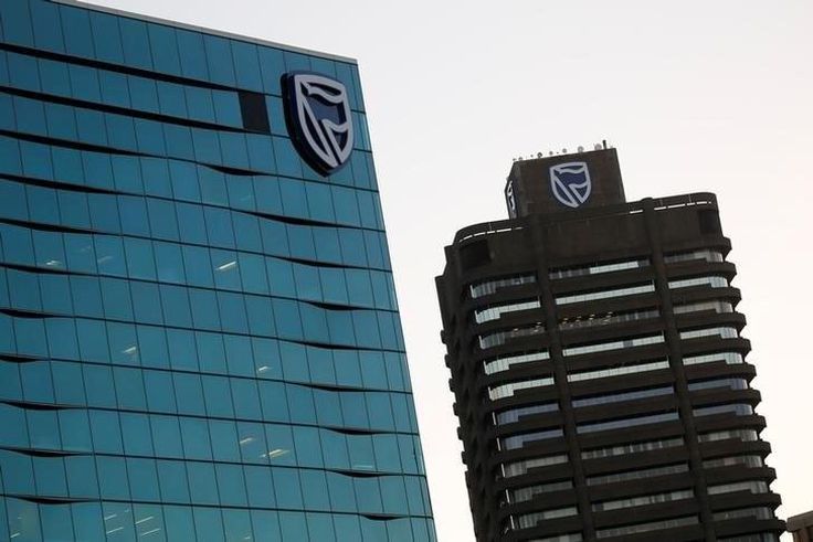 The logo of South Africa's Standard Bank is seen above the company's headquarters in Cape Town, South Africa May 6, 2016. REUTERS/Mike Hutchings/File Photo
