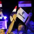 People hold EgyptAir flags during a candlelight vigil for the victims of EgyptAir flight 804, at the Cairo Opera House in Cairo, Egypt May 26, 2016.