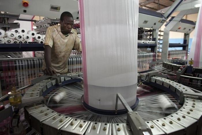 A worker fabricates a plastic bag designed to hold cotton at the Badenya Company factory in Koutiala August 31, 2012.
