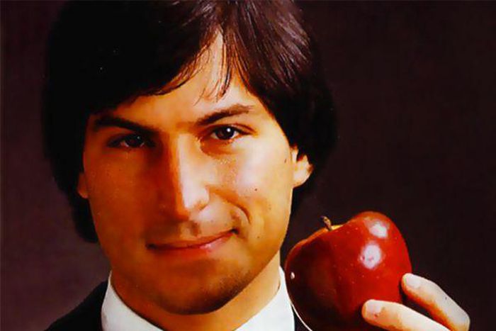 Steve Jobs holding an Apple