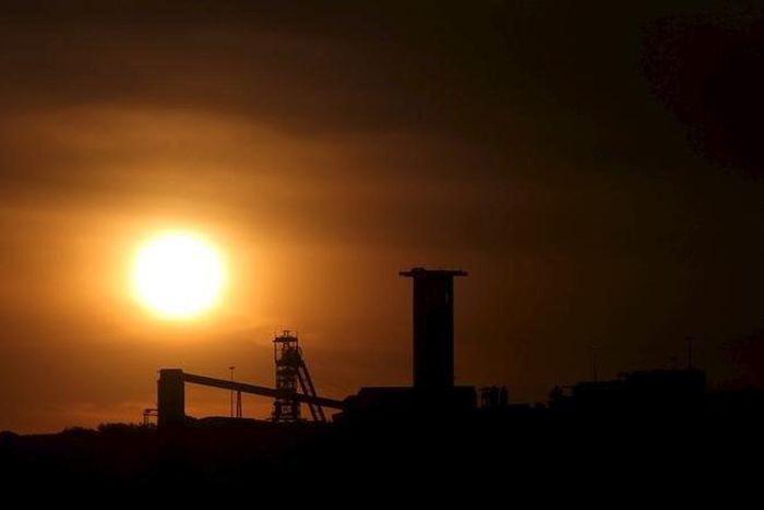The sun sets behind a shaft outside the mining town of Carletonville, west of Johannesburg, July 7 2015.