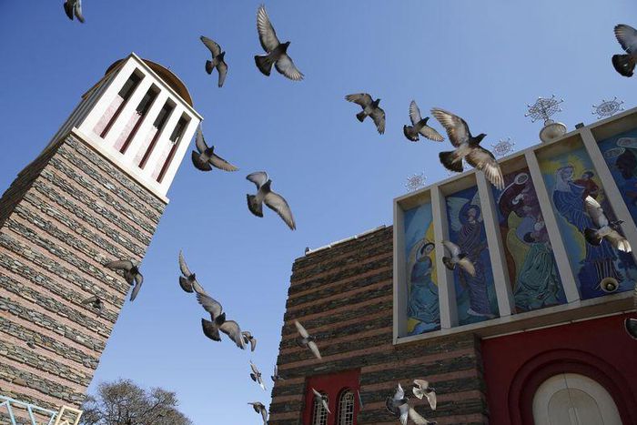 Pigeons fly outside the Nda Mariam Orthodox Cathedral in Eritrea's capital Asmara, February 16, 2016. REUTERS/Thomas Mukoya