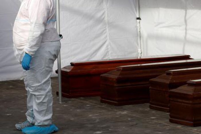 Coffins containing dead migrants removed from Italian navy ships "Bettica" are seen in the Sicilian harbour of Porto Empedocle, Italy, May 26, 2016.