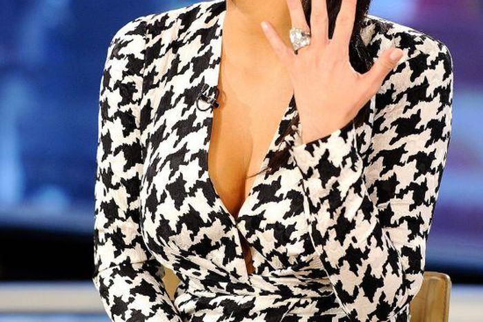 Kim Kardashian shows off her rock wearing her signature sleek ponytail