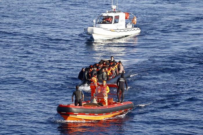 A Turkish Coast Guard fast rigid-hulled inflatable boat tows a dinghy filled with refugees and migrants in the Turkish territorial waters of the North Aegean Sea, following a failed attempt at crossing to the Greek island of Chios, off the shores of Iz...