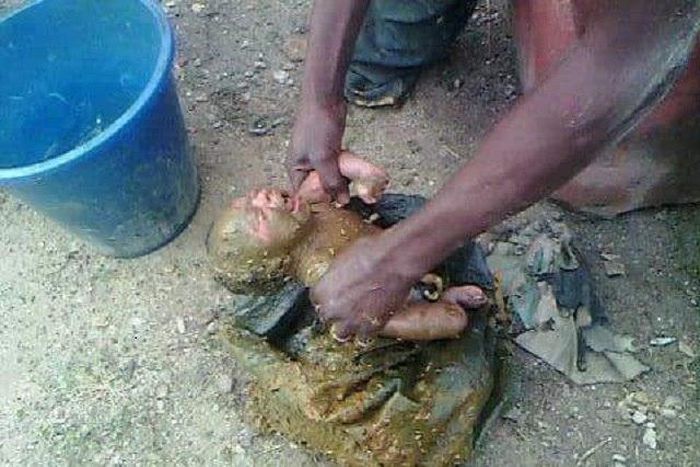 The baby after he was rescued from the toilet