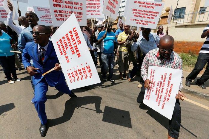Kenyan taxi drivers signed up to ride-hailing service Uber chant slogans and dance along the streets during a strike after the company slashed prices in the face of growing competition from similar local firms in Kenya's capital Nairobi, August 2, 2016...
