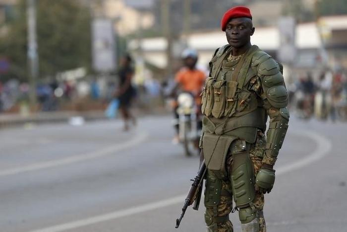 A soldier holds his weapon as he watches a procession by Uganda's leading opposition party Forum for Democratic Change supporters being dispersed in Kampala, Uganda, February 15, 2016.