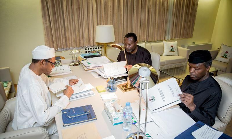 President Muhammadu Buhari, Vice President Yemi Osinbajo and Minister of Budget and National Planning Senator Udoma Udo Udoma read copies of the details of the submitted 2016 national budget by the National Assembly in Abuja, Nigeria April 10, 2016