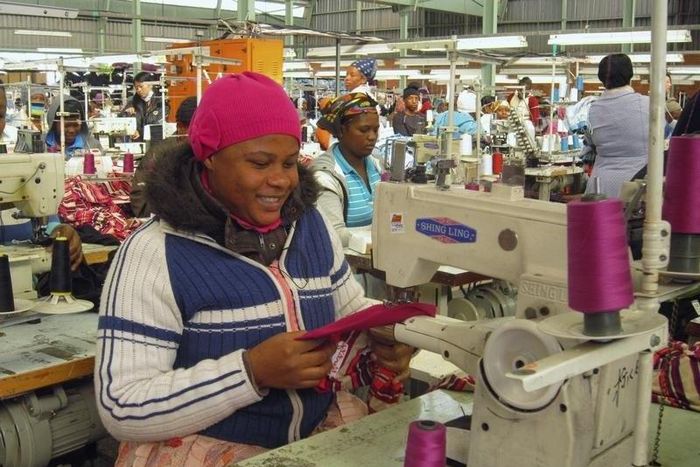 People work on machines at a clothing factory at an industrial town of Newcastle, 260 km (162 miles) southeast of Johannesburg May 8, 2013.