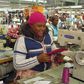 People work on machines at a clothing factory at an industrial town of Newcastle, 260 km (162 miles) southeast of Johannesburg May 8, 2013.